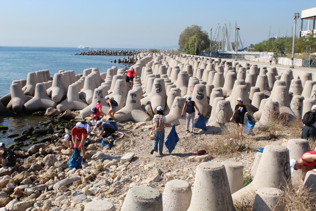 group of TP employees cleaning up a beach in Athens