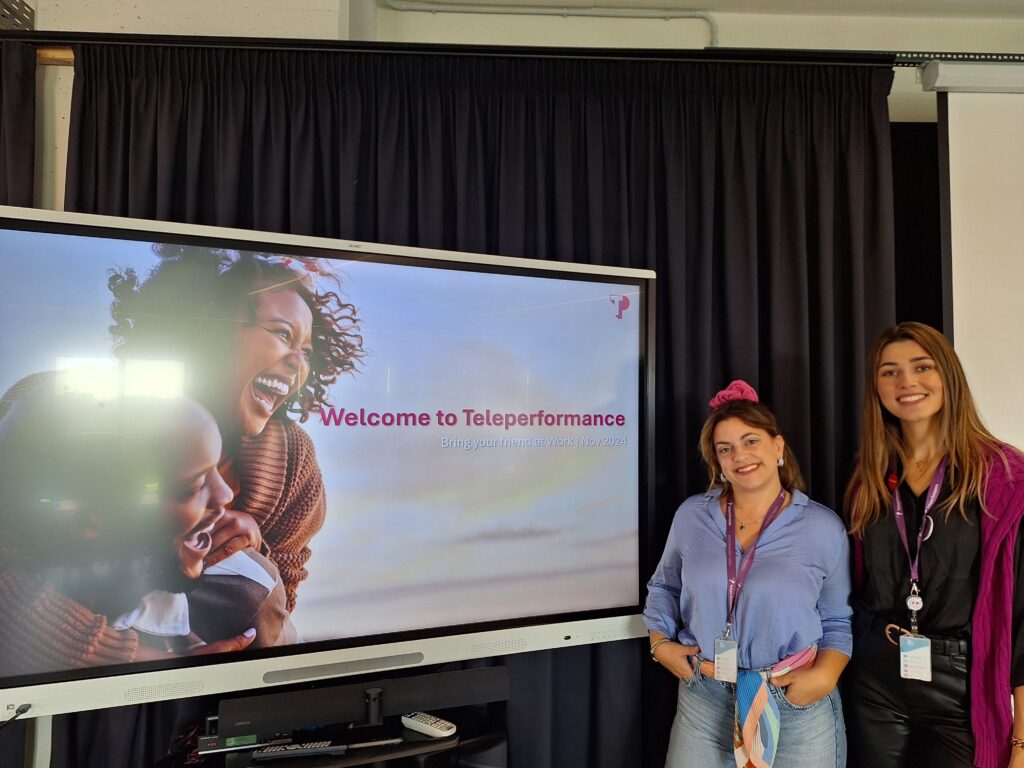 2 TP employees posing during "Bring Your Friend at Work" initiative