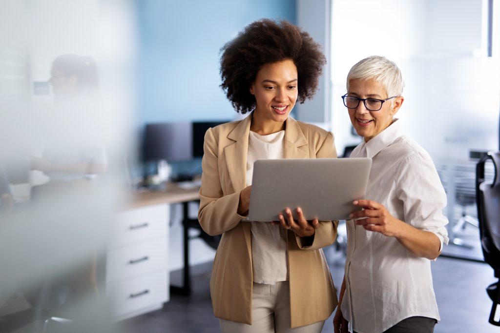 Happy Smiling, Business Women Working Together Online on a Laptop