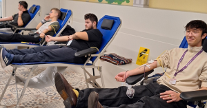 4 people giving blood during day one of blood drive