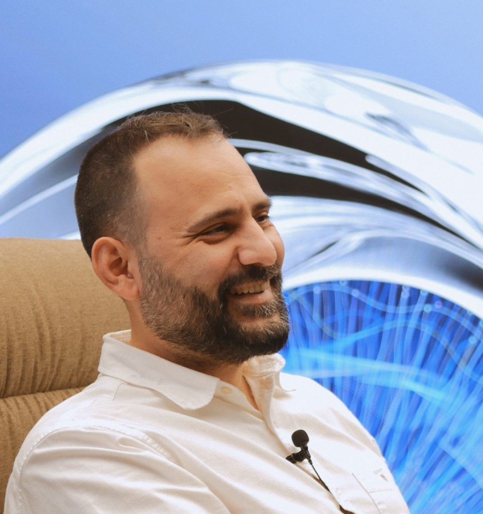 Man smiling at the innovation lounge of TP in Greece