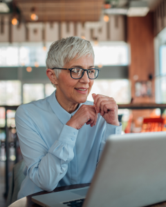 old lady with grasses in front of laptop