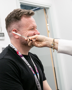 TP Employee smiling and getting exanimated for world hearing day 2026